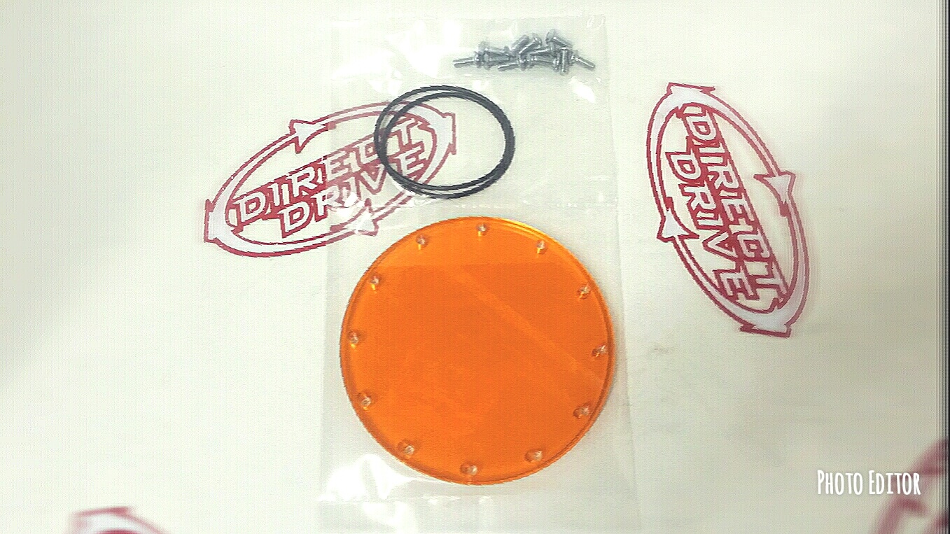 An orange lens with bolts and O ring